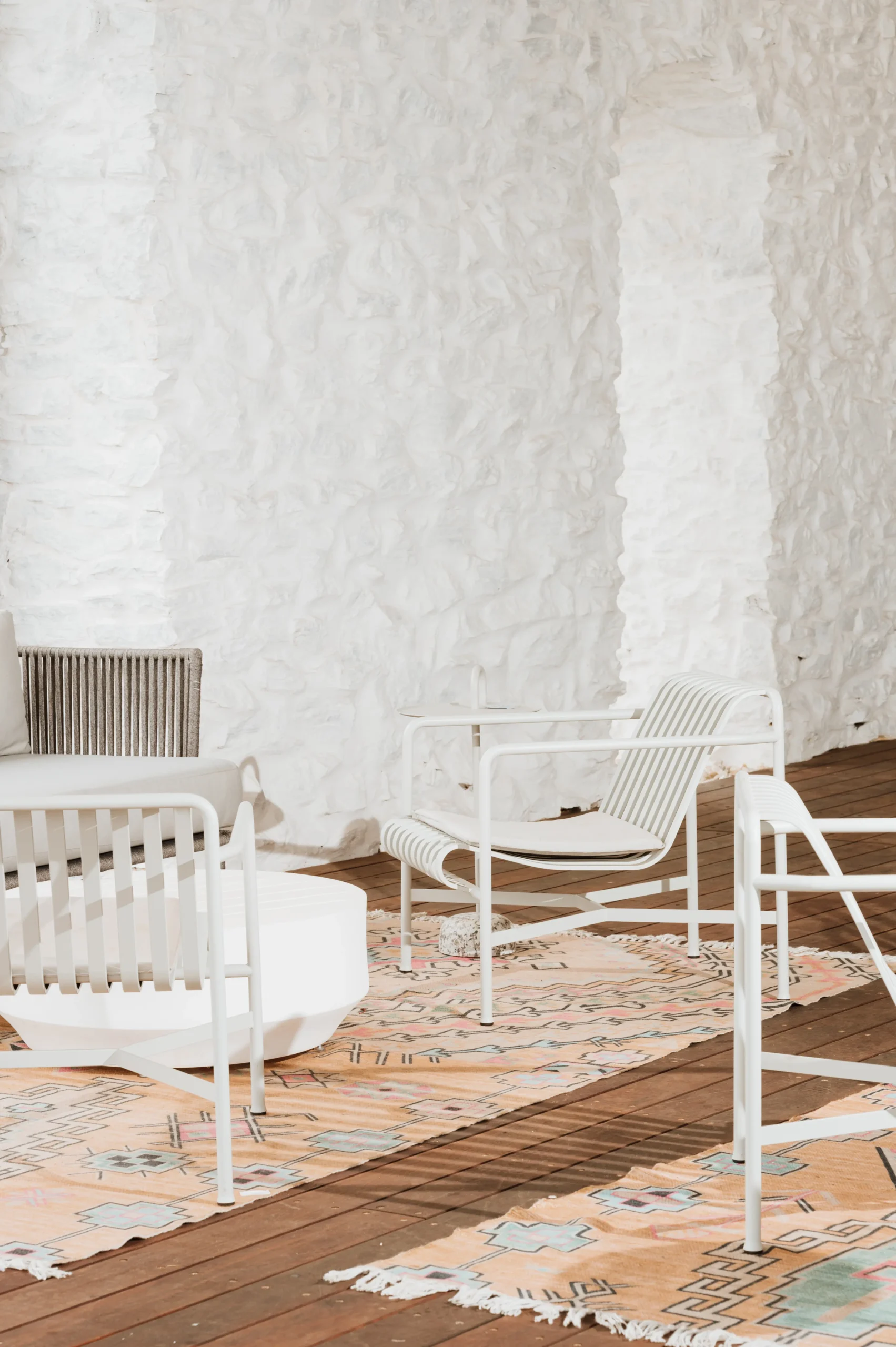 Photo of the Alfresco desk with white washed walls and comfortable looking lounge chairs