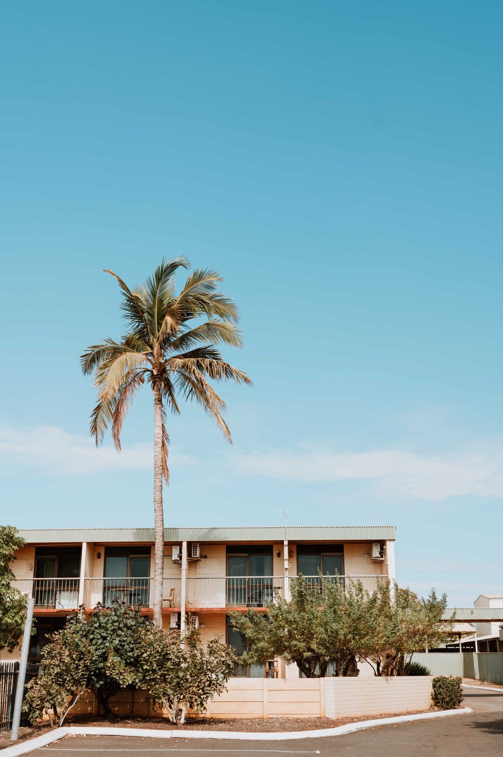 The view out the front of some rooms at the Hedland Hotel with trees in front of them