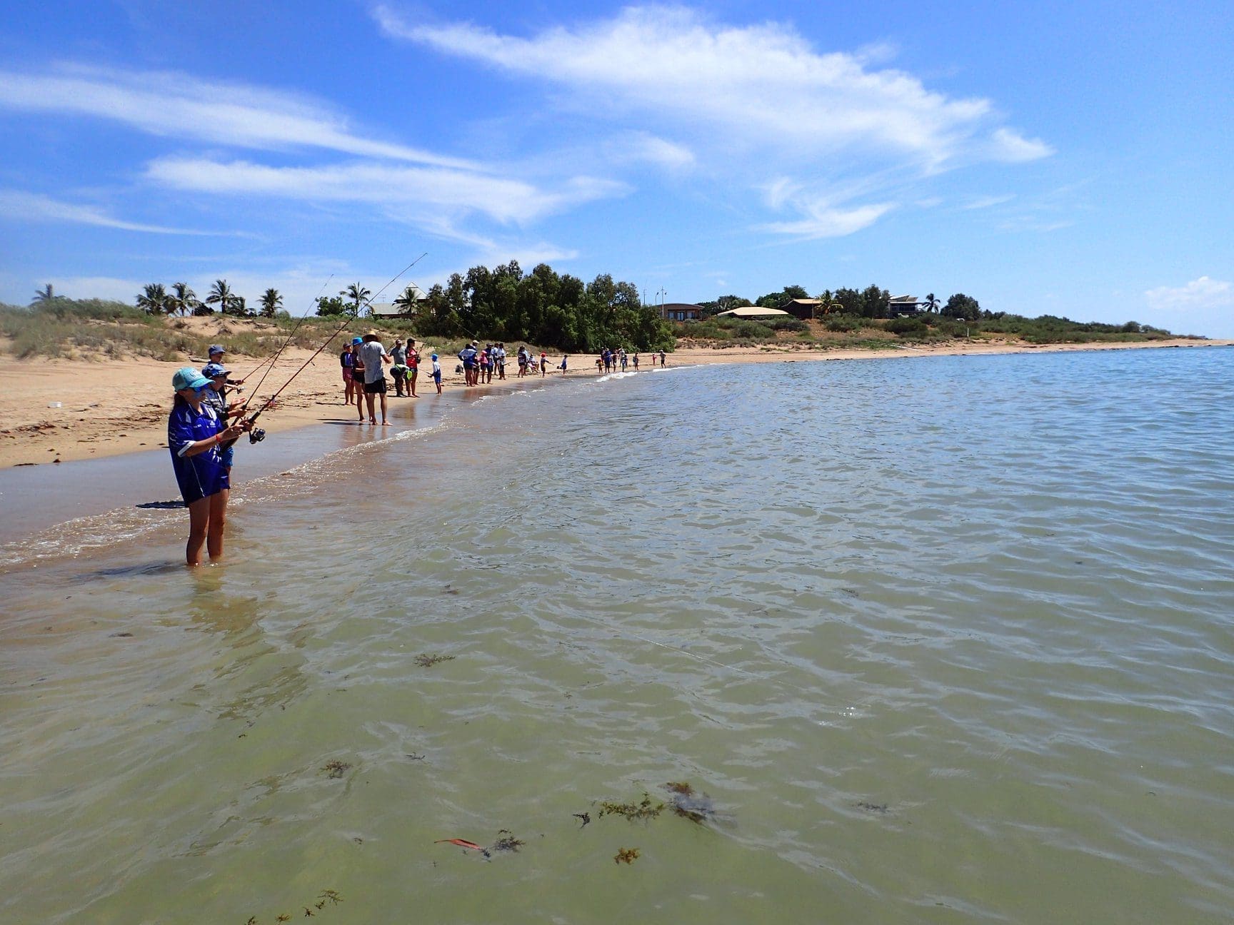 A group of people fishing at Point Sampson beach